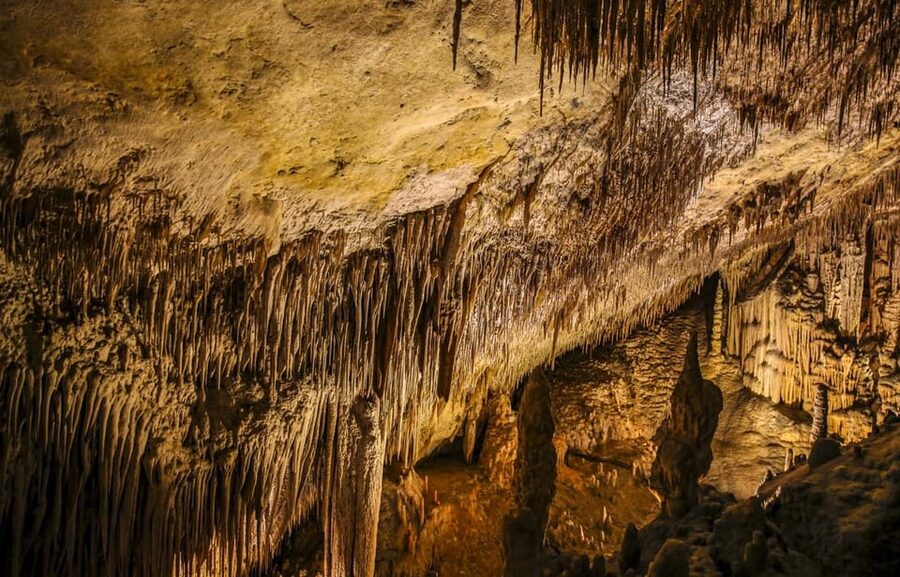 Palma: Caves of Drach Entrance, Music Concert, and Boat Trip - Walking through the underground chambers